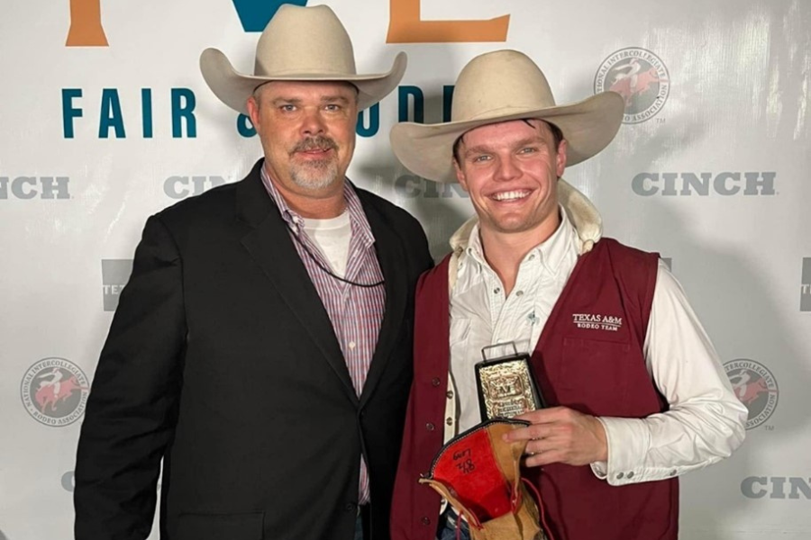 two men in cowboy hats posing with an award