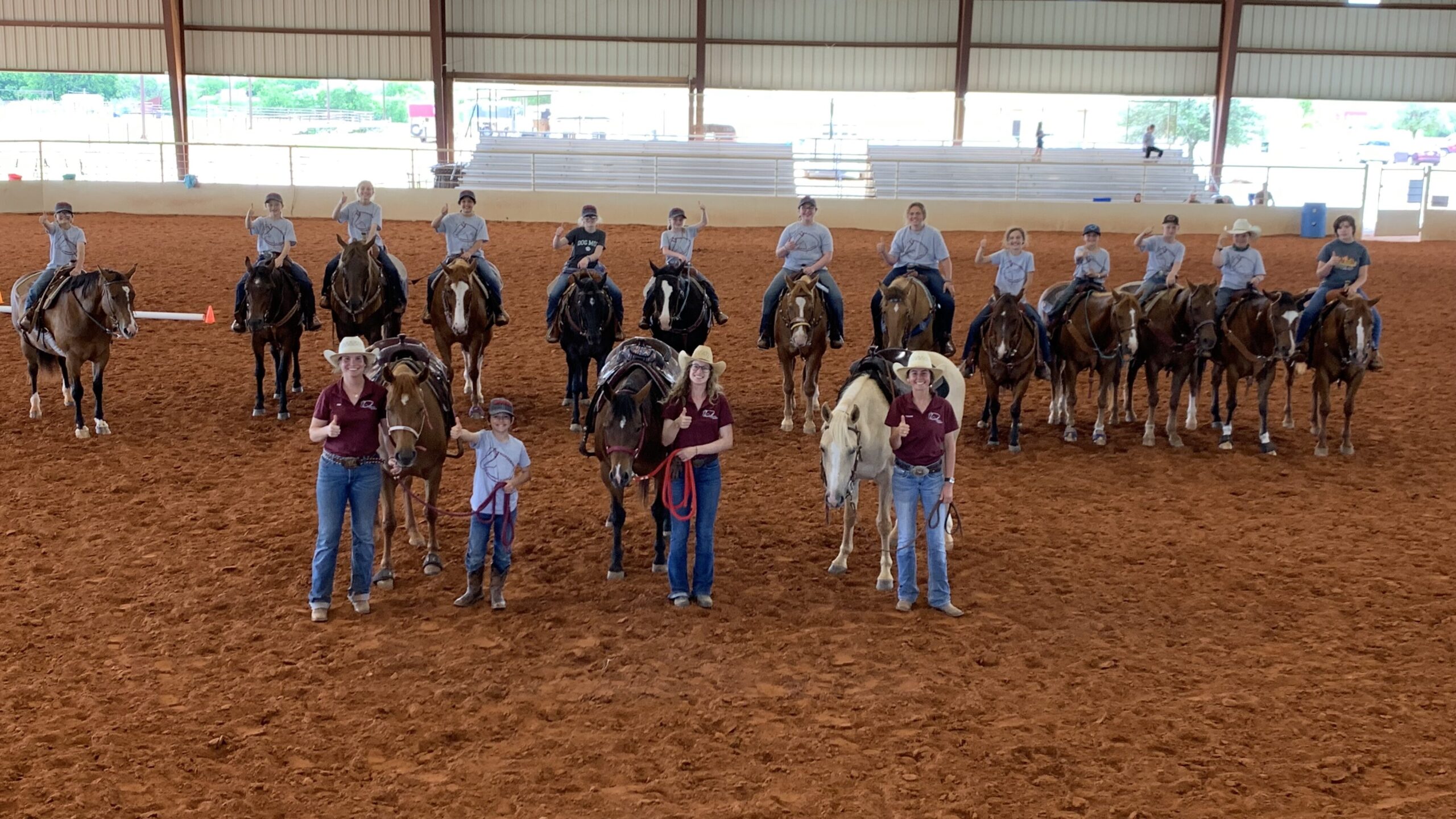 People on horses in an arena.
