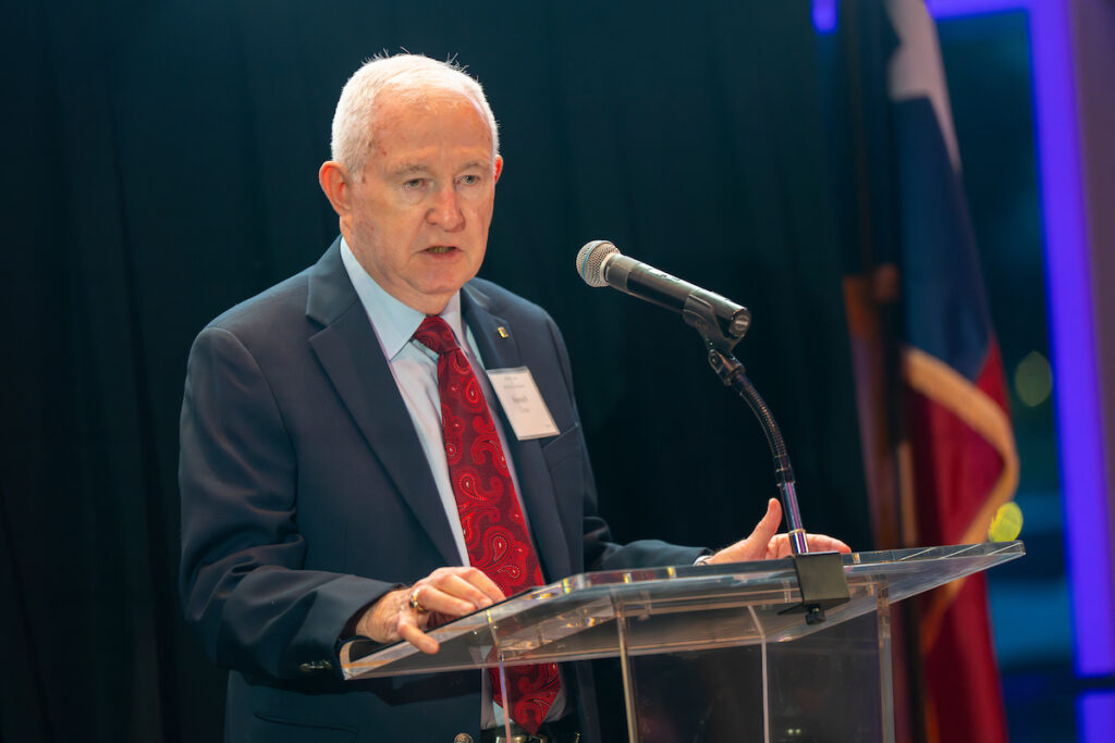 Russell Cross standing at a podium