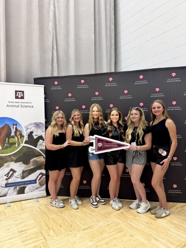 Students posing for a photo at the Texas A&M Animal Science Tailgate